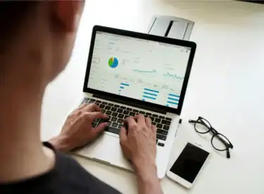 Professional reviewing analytics dashboards on a laptop, illustrating how enterprises measure billing and revenue performance metrics.