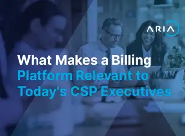 Two colleagues reviewing a laptop in a modern office under a blue overlay, with the article title on billing platform relevance for CSP executives.